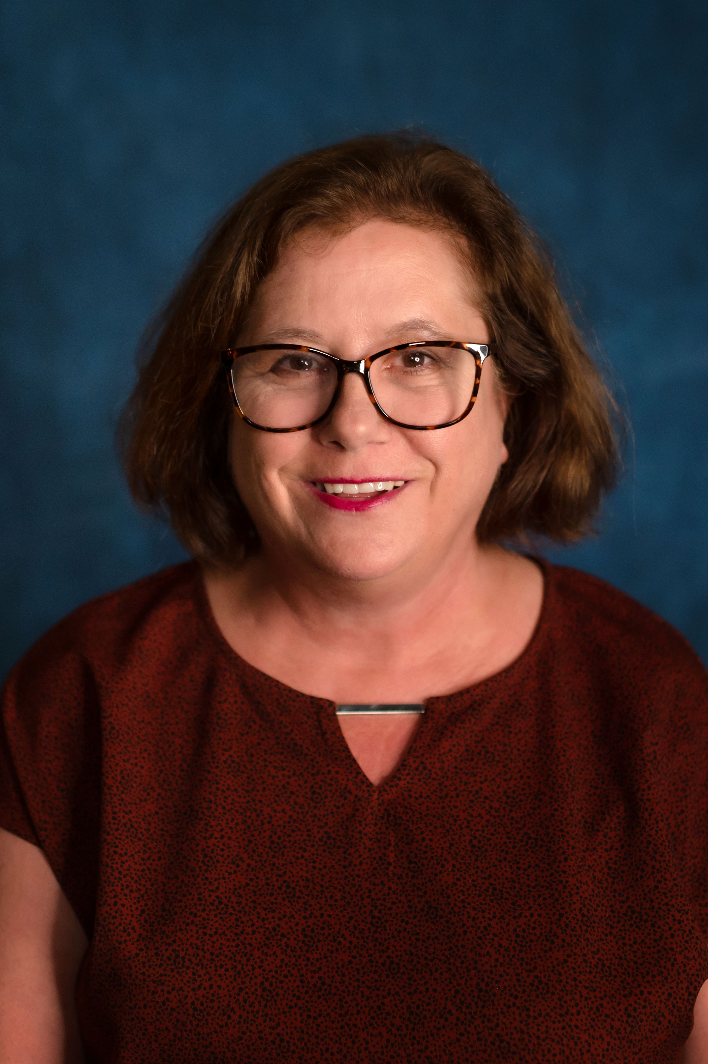 headshot of Nancy on a blueback ground